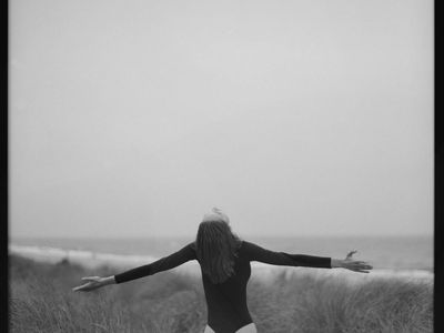 A gentle stretching pose in a bright, open space.