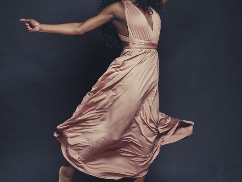 Person in mid-flow of a dynamic cardio movement.